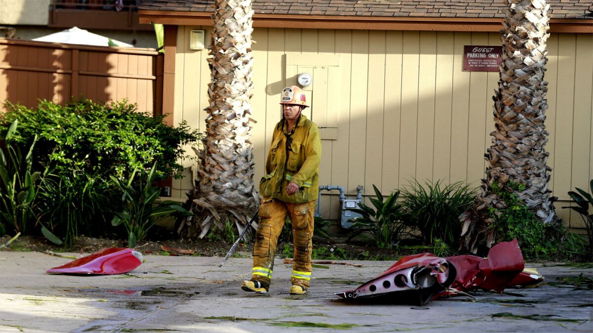A firefighter walks among debris after the Hawthorne crash.