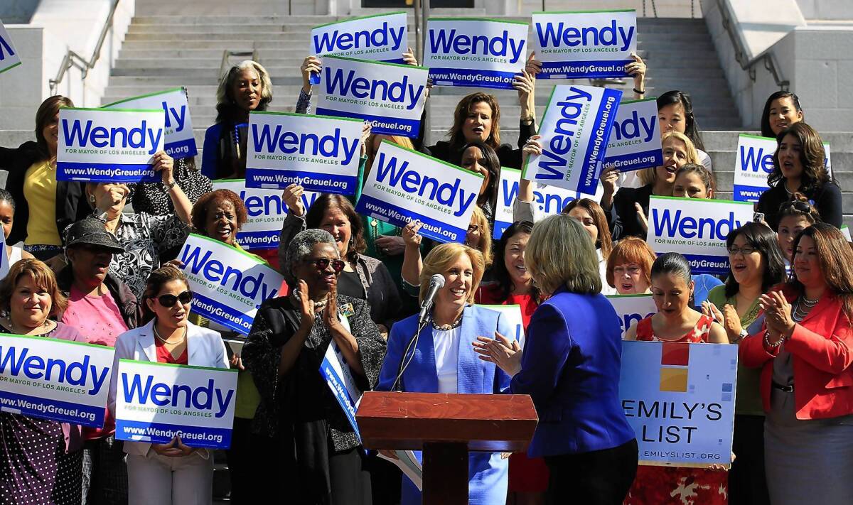 Wendy Greuel, center, is joined by EMILY's List President Stephanie Schriock, center right, on Friday during a City Hall news conference at which the city controller accepted the group's endorsement for mayor.