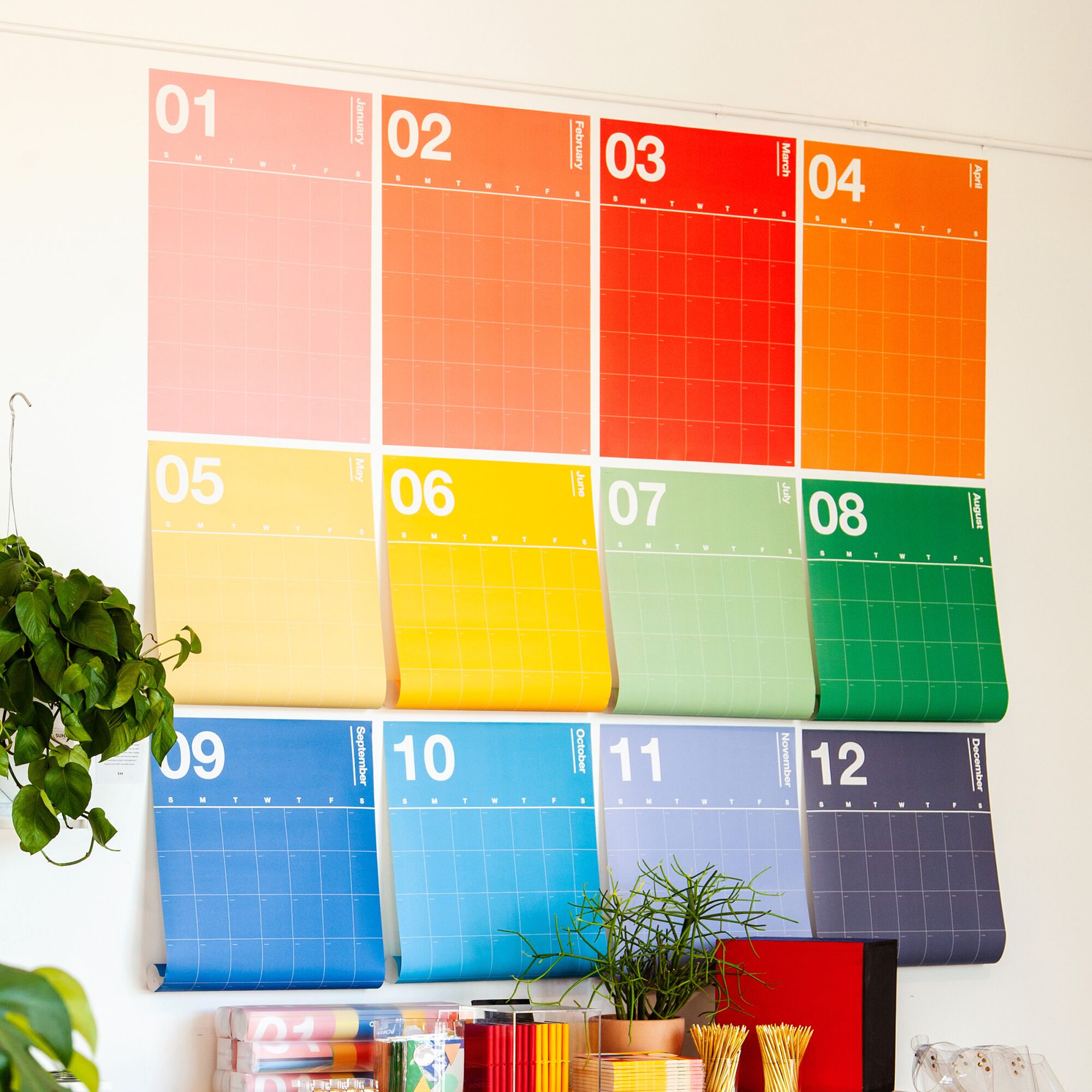 A colorful wall planner with a sheet for each month.