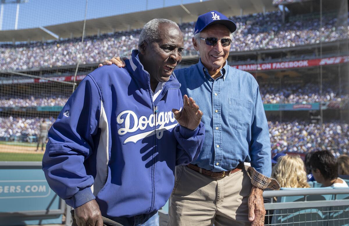 Former Dodgers outfielder Lou Johnson, left, attends a game at Dodger Stadium with former pitcher Sandy Koufax in March 2019.
