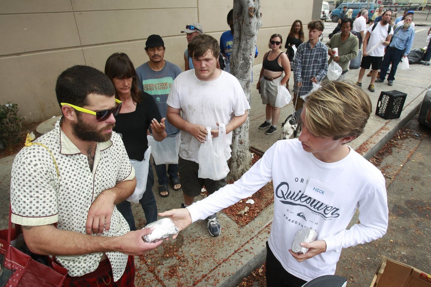 Burrito Boyz member Nick Peelman,18, hands egg burritos out to people, most of them homeless, in downtown San Diego.