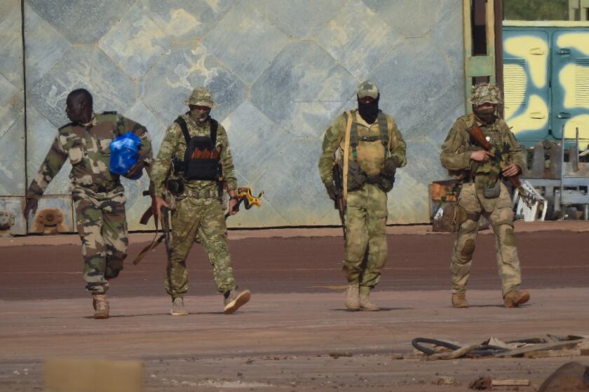 This undated photograph handed out by French military shows three Russian mercenaries, right, in northern Mali. Western officials say violence against civilians in Mali has risen in the year since hundreds of Russian mercenaries have started working alongside the West African country's armed forces to stem a decade-long insurgency by Islamic extremists. Diplomats, analysts and human rights groups say extremists linked to al-Qaida and the Islamic State group have only gotten stronger and there's concern the Russian presence will further destabilize the already-troubled region.(French Army via AP)