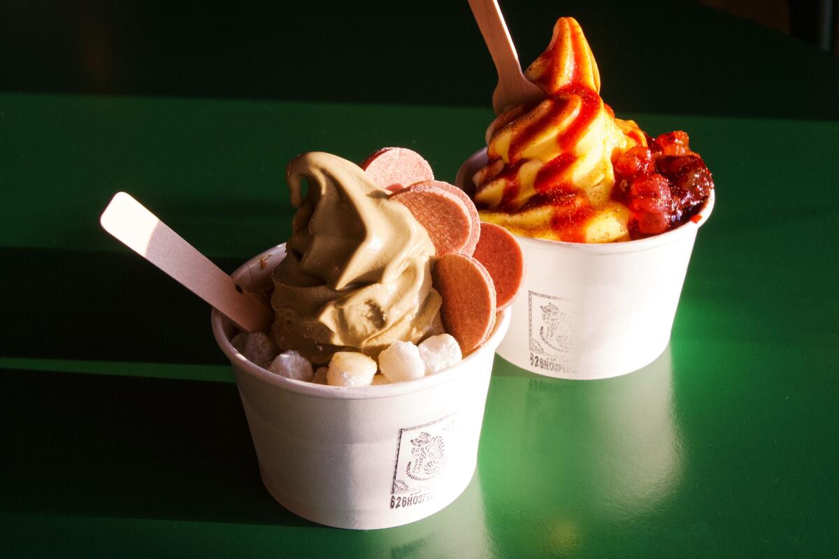 Two cups of soft serve with toppings from 626 Hospitality in Arcadia. In foreground, hojicha with mochi. Behind, calamansi