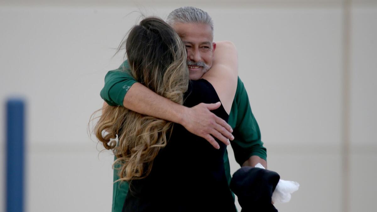 Romulo Avelica Gonzalez embraces his daughter last year after being released from the Adelanto Detention Facility. In an interview, he describes harsh conditions there.