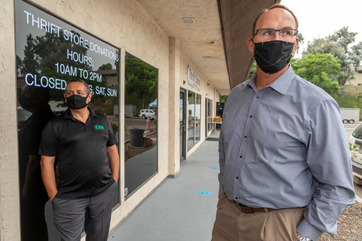 Tim Yzaguirre stands outside Bread of Life Rescue Mission with Donnie Dee.