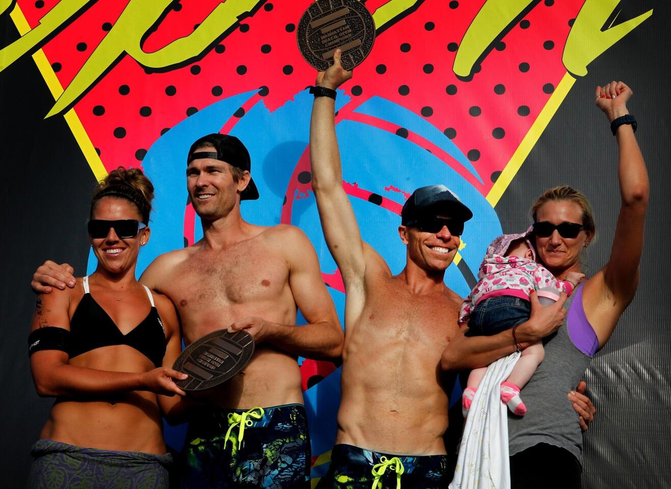 Whitney Pavlik, Matt Fuebringer, Casey Jennings, and Kerri Walsh (left to right) -- holding baby Scout that she had with husband Casey Jennings -- stand at the podium after winning at the Manhattan Beach Open Volleyball finals on Aug. 25, 2013.