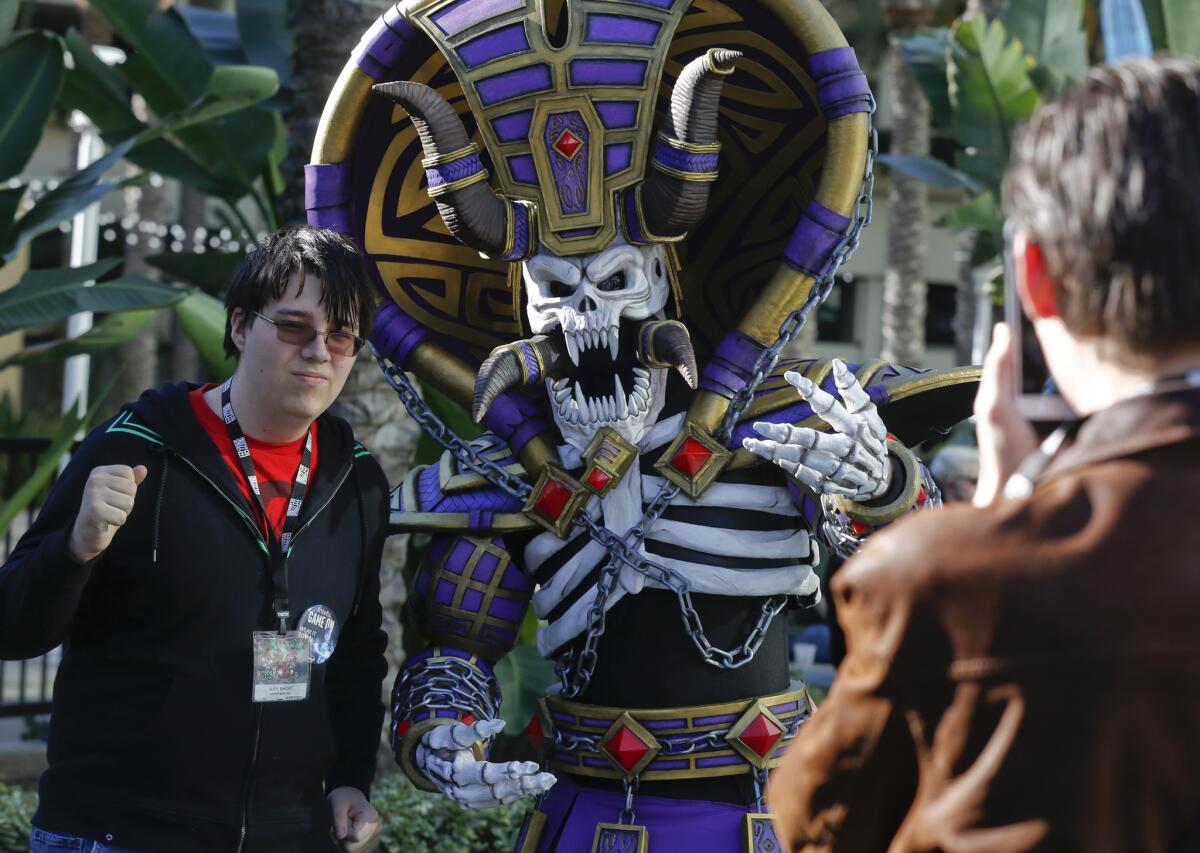 Fan Michael Casteel wears his "World Of Warcraft" costume while other fans pose for photos of him during BlizzCon at the Anaheim Convention Center on Friday.