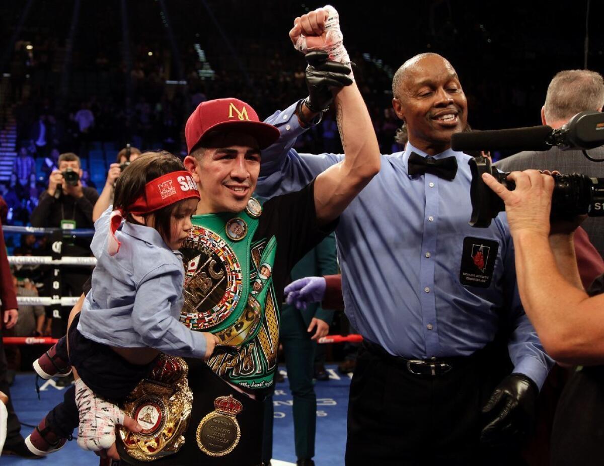 Leo Santa Cruz celebrates his majority-decision win over Carl Frampton after their WBA featherweight title fight in Las Vegas on Jan. 28.