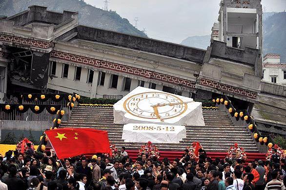 On the first anniversary of the earthquake that killed or left missing 90,000 residents in China's Sichuan province, people gather by a marble monument marking the epicenter in Wenchuan in southwest Sichuan.
