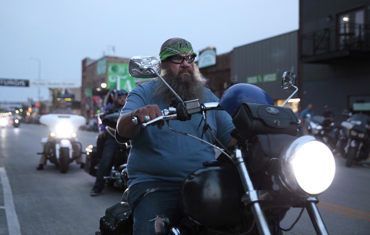 Motorcycles cruise through downtown Sturgis, S.D.