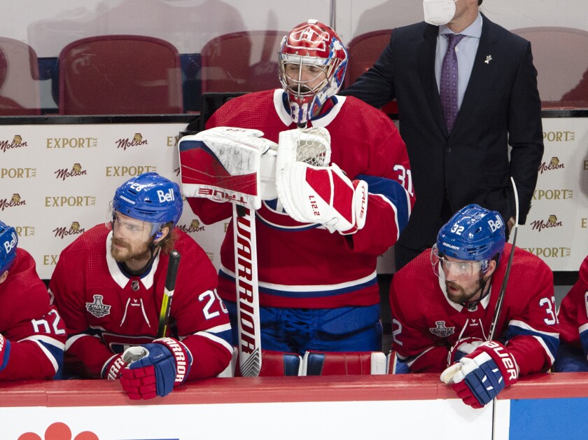 Montreal Canadiens goaltender Carey Price (31) watches from the bench after being pulled for an extra attacker during the third period of Game 3 against the Tampa Bay Lightning in the NHL hockey Stanley Cup Final, Friday, July 2, 2021, in Montreal. (Ryan Remiorz/The Canadian Press via AP)