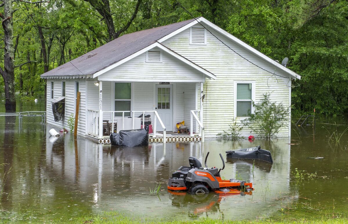 Water surrounds a house along flooded areas on Bluff Road Tuesday, May 18, 2021, in Ascension Parish, La. Heavy rains have swept across southern Louisiana, flooding homes, swamping cars and closing a major interstate. (Bill Feig/The Advocate via AP)