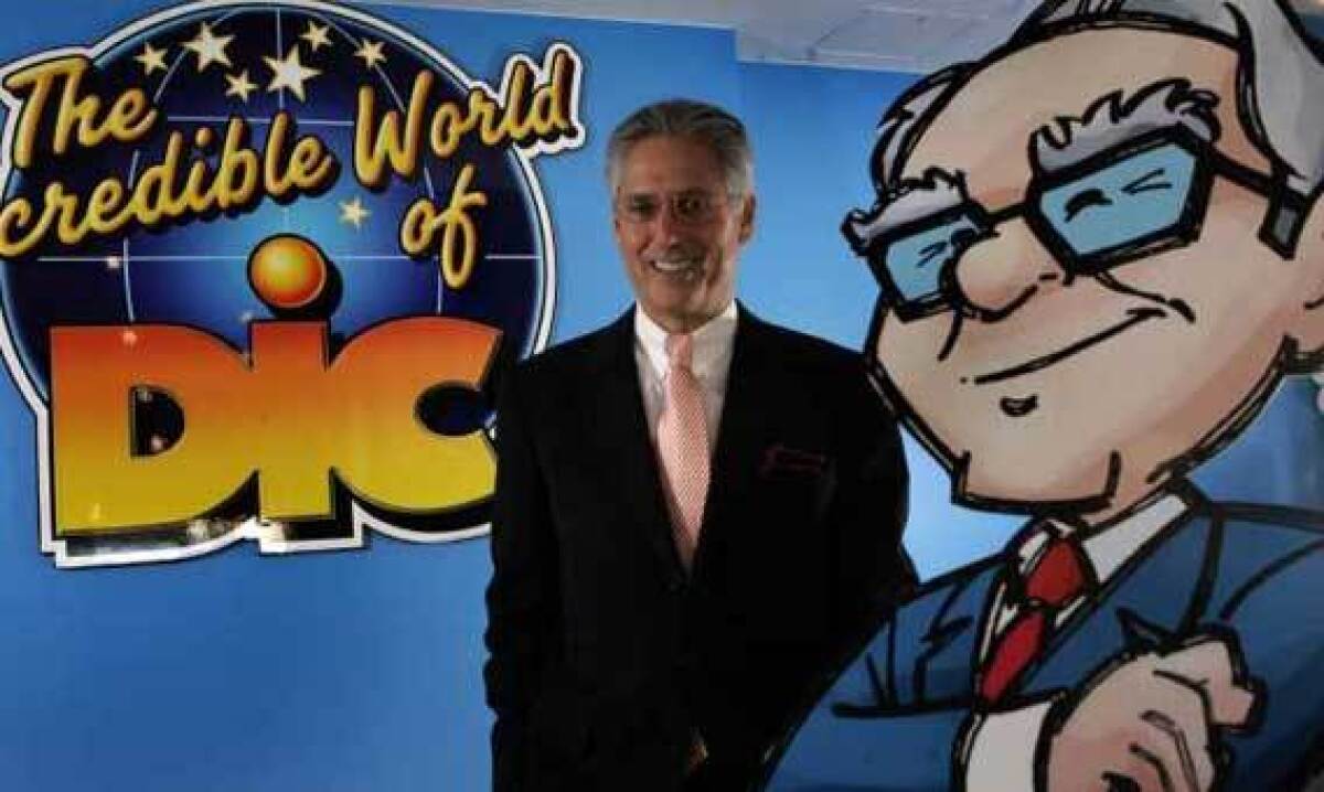 A 2006 file photo shows then DIC Entertainment chief Andy Heyward standing beside a cartoon rendering of Warren Buffett from the DVD series "The Secret Millionaire's Club."
