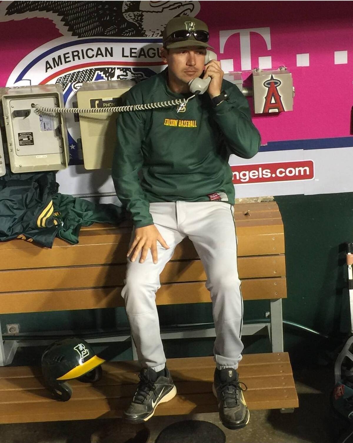 Aaron Pines makes a call to the bullpen for the Los Amigos High School baseball team.