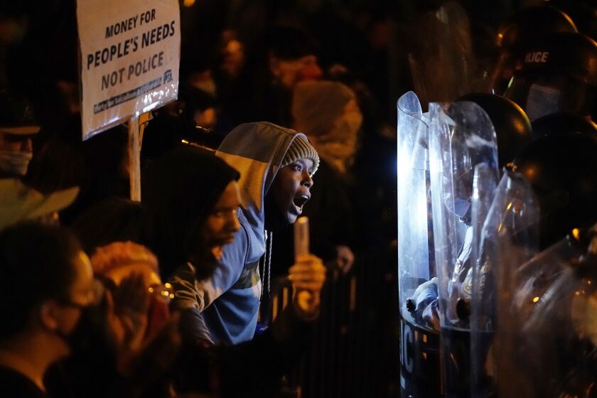 Protesters confront police during a march, Tuesday, Oct. 27, 2020, in Philadelphia. Hundreds of demonstrators marched in West Philadelphia over the death of Walter Wallace, a Black man who was killed by police in Philadelphia on Monday. Police shot and killed the 27-year-old on a Philadelphia street after yelling at him to drop his knife. (AP Photo/Matt Slocum)