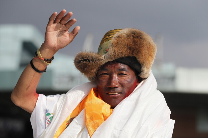 FILE - In this May 20, 2018, file photo, Nepalese veteran Sherpa guide, Kami Rita waves as he arrives in Kathmandu, Nepal. Rita, 51, an ace Sherpa guide scaled Mount Everest Friday for the 25th time breaking his own record for the most successful ascents of the world’s highest peak. (AP Photo/Niranjan Shrestha, File)
