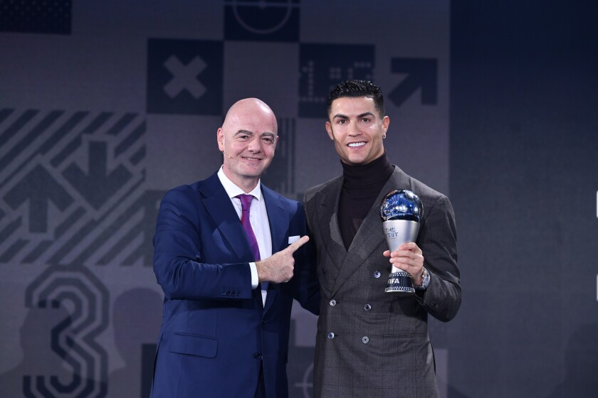 FIFA President Gianni Infantino, left, presents the FIFA Special Best Men's award to Cristiano Ronaldoduring the Best FIFA Football Awards 2021 in Zurich, Switzerland, Monday, Jan. 17, 2022. (Harold Cunningham/Pool Photo via AP)