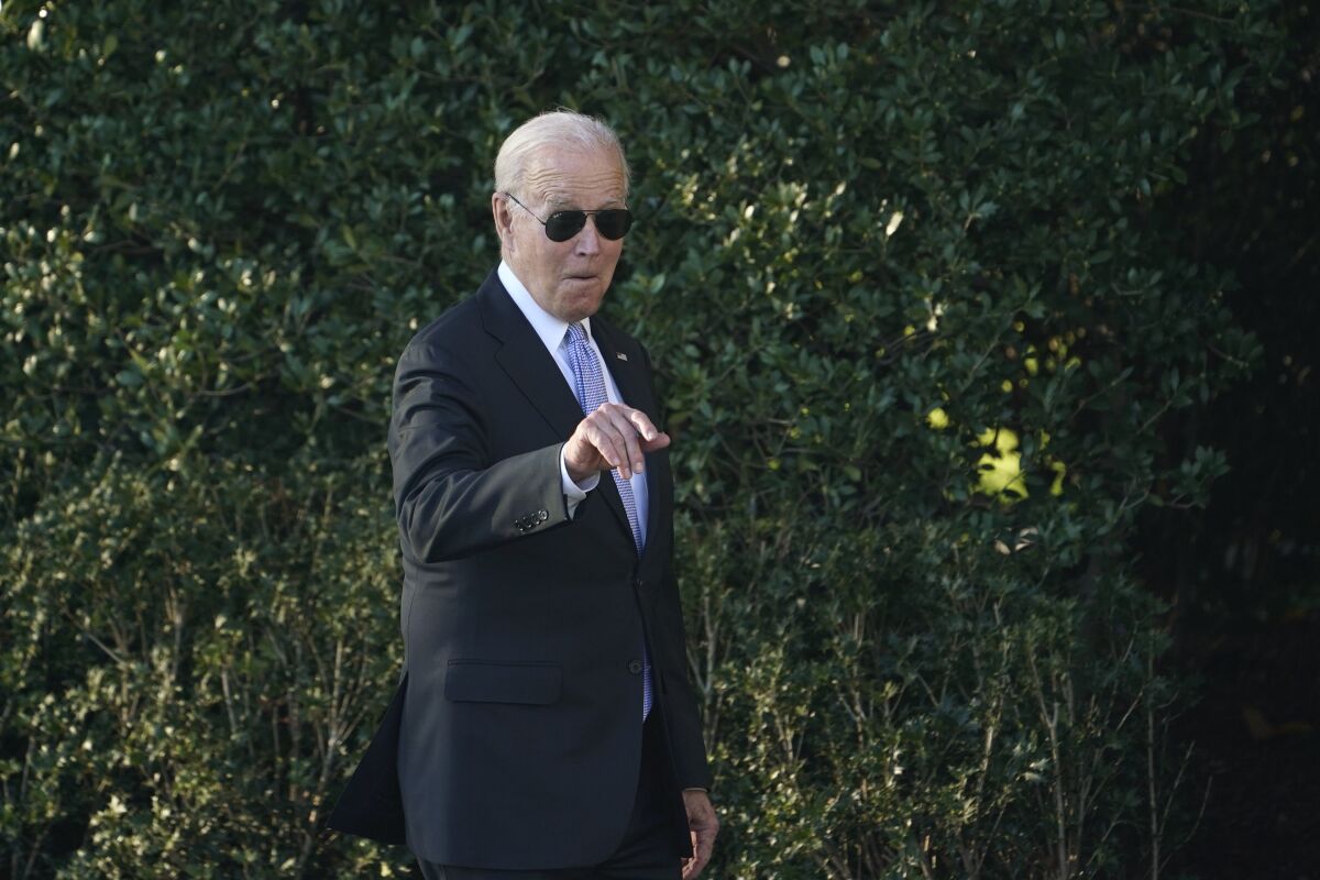 President Joe Biden points out someone in the audience as he arrives for an event to welcome the Milwaukee Bucks basketball team to the White House to celebrate their 2021 NBA Championship, on the South Lawn of the White House in Washington, Monday, Nov. 8, 2021. (AP Photo/Susan Walsh)