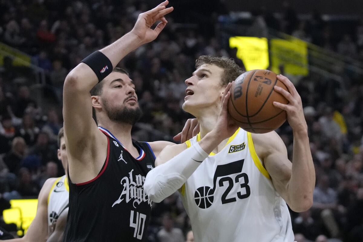 Los Angeles Clippers center Ivica Zubac (40) defends against Utah Jazz forward Lauri Markkanen (23) during the first half of an NBA basketball game Wednesday, Jan. 18, 2023, in Salt Lake City. (AP Photo/Rick Bowmer)