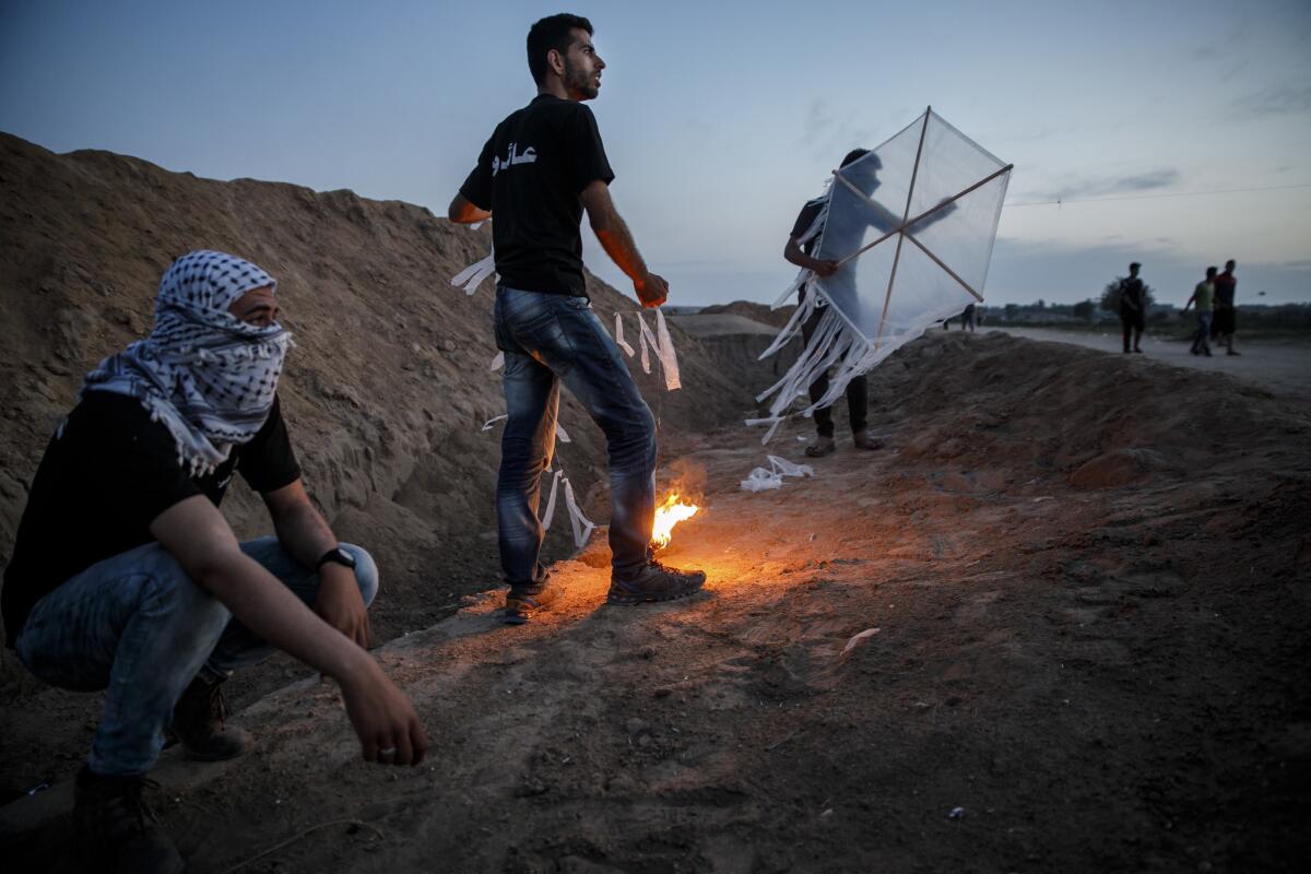 Palestinians test out kites that carry torches, to use for the Great March of Return, at the Bureij refugee camp near Deir al-Bala, Gaza Strip, on May 9.