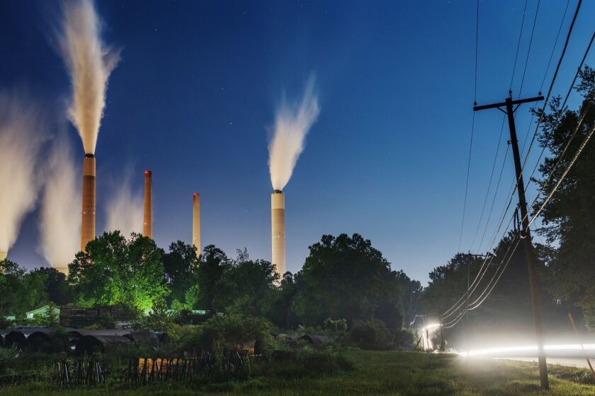 The John E. Amos Power Plant is seen from a field outside of Winfield, W. Va., on Thursday night, Aug. 23, 2018. Built in the 1970's, the coal-fired facility is the largest in the American Electric Power company's portfolio. Many of AEP's smaller coal-fired power plants in Appalachia closed in response to environmental regulations such as the Clean Power Plan in 2015. (Craig Hudson/Charleston Gazette-Mail via AP)