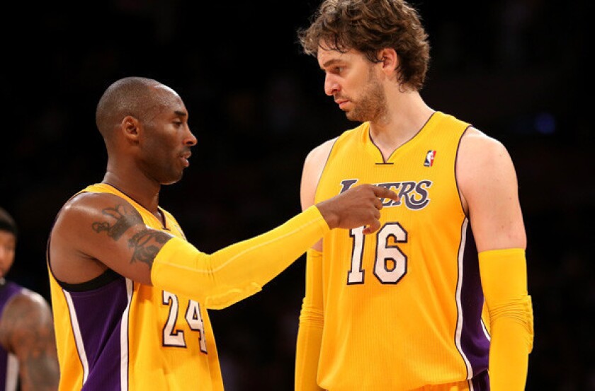 Lakers guard Kobe Bryant talks to power forward Pau Gasol during their exhibition game against the Kings.