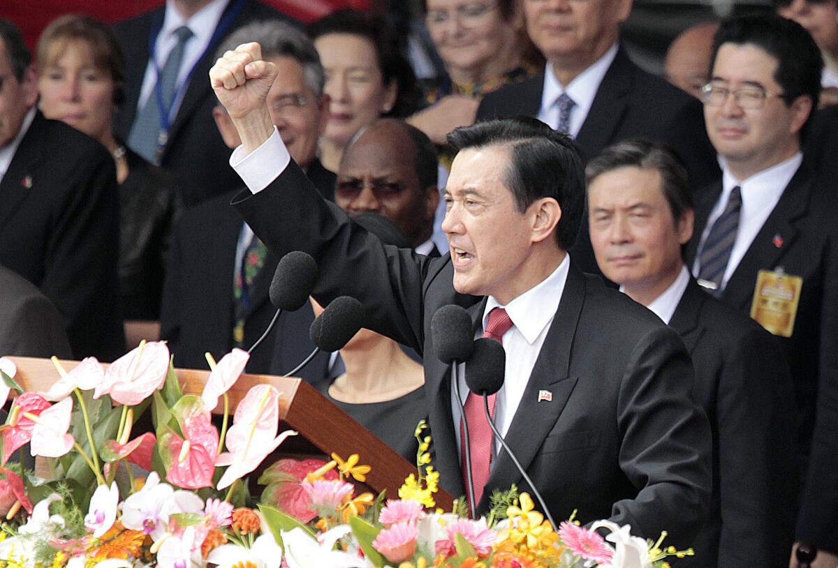 Taiwan's President Ma Ying-jeou, front, cheers with the audience during National Day celebrations in Taipei on Friday.