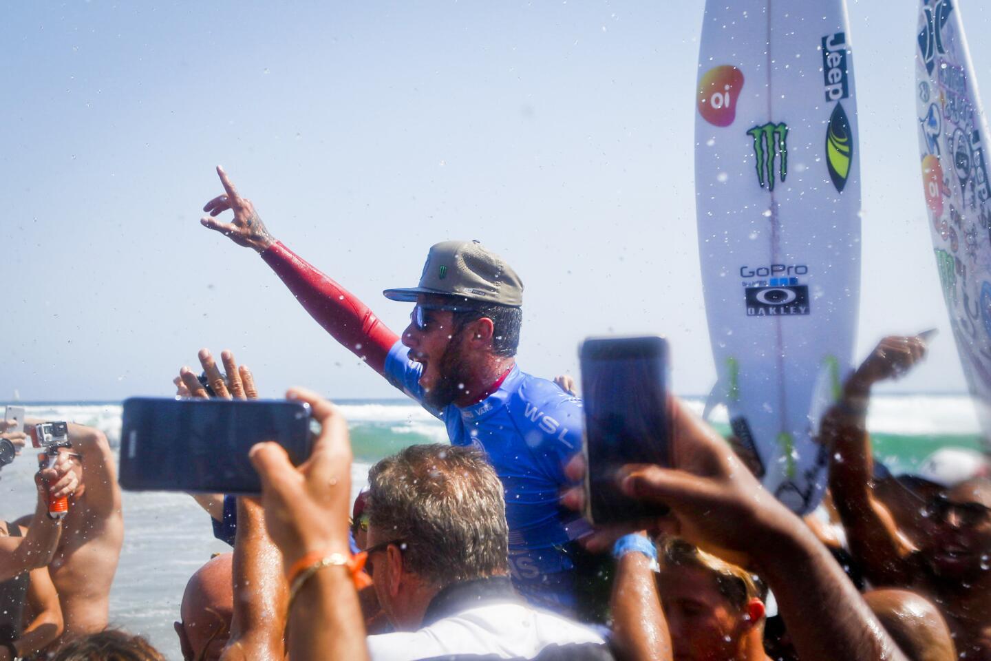 Filipe Toledo celebrates with fans after winning the men's title at the 2016 U.S. Open of Surfing in Huntingon Beach on Sunday.
