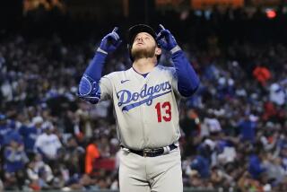 Los Angeles Dodgers' Max Muncy gestures after hitting a three-run home run.