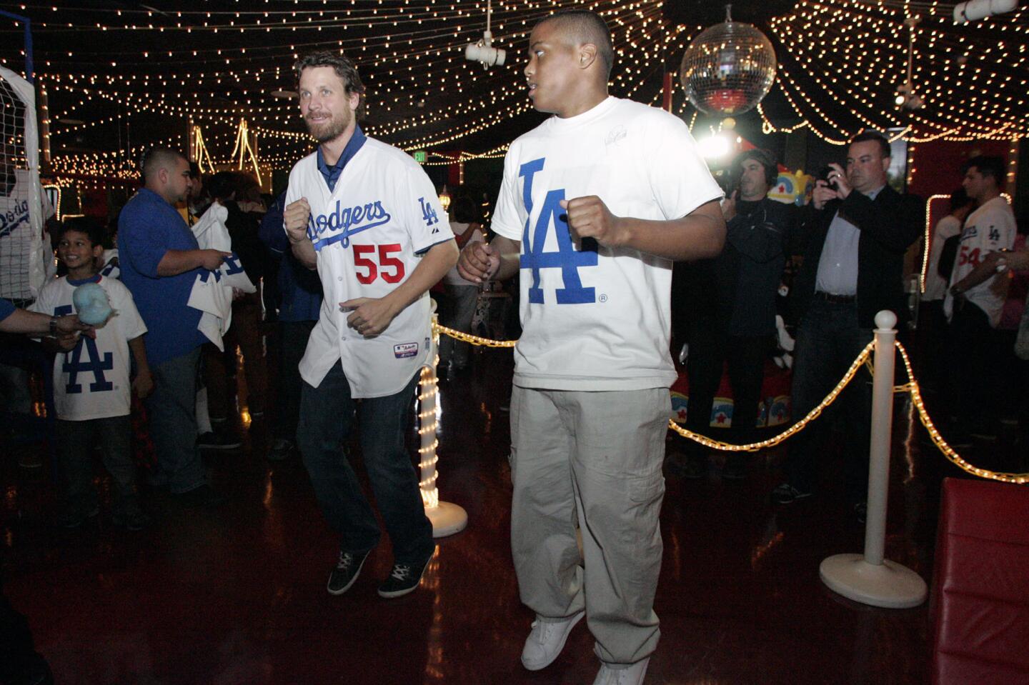 LA Dodgers' Matt Guerrier, from third left, dances with Jonathan McCowan during the Dodgers 10th annual Community Caravan "Pitching in the Community," which took place at Tobinworld in Glendale on Friday, January 25, 2013.