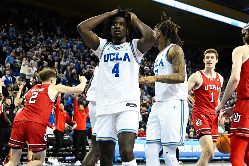 UCLA guard Will McClendon reacts after Utah center Branden Carlson scores with less than a second remaining.