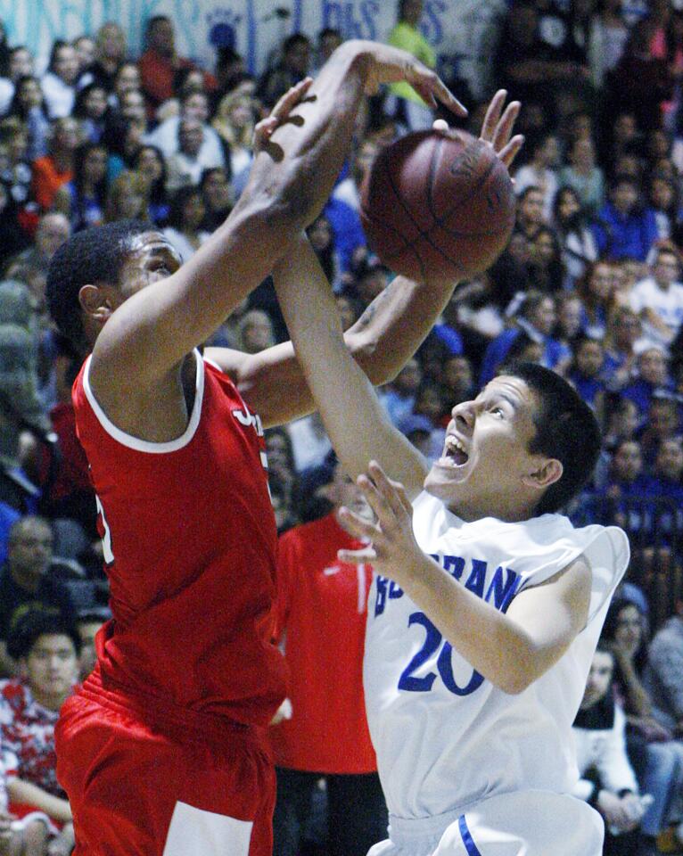 Burroughs' Amaad Wainright battles for a rebound against Burbank's Adrian Gonzalez in a rival Pacific League boys basketball game at Burbank High on Friday, January 24, 2014. (Tim Berger/Staff Photographer)