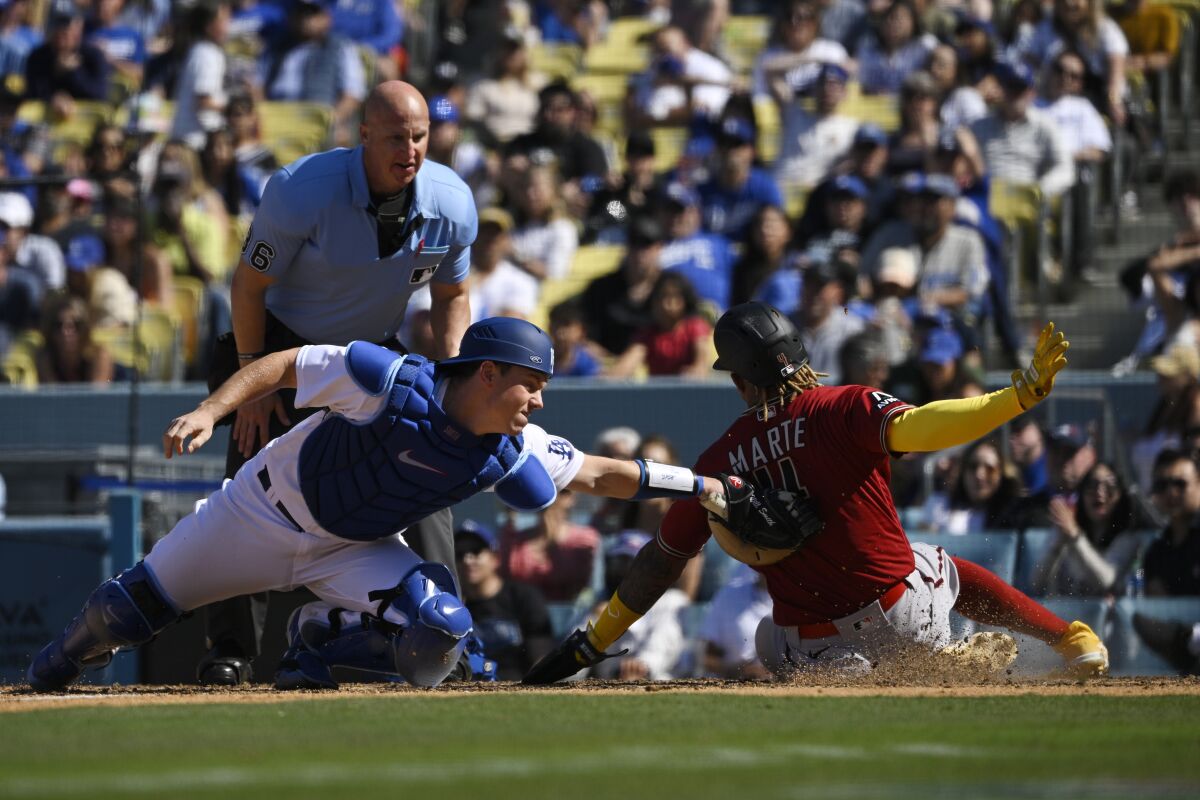 Dodgers catcher Will Smith tags out Arizona's Ketel Marte at home plate in the ninth inning Sunday.