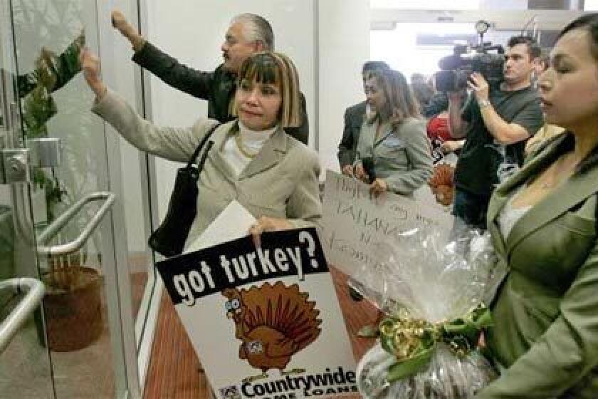 DELIVERING A MESSAGE: Activists at Countrywide Financial offices in San Diego demand a halt to foreclosure proceedings for those behind in home payments as well as modification of adjustable-rate mortgages on which payments are due to move higher.