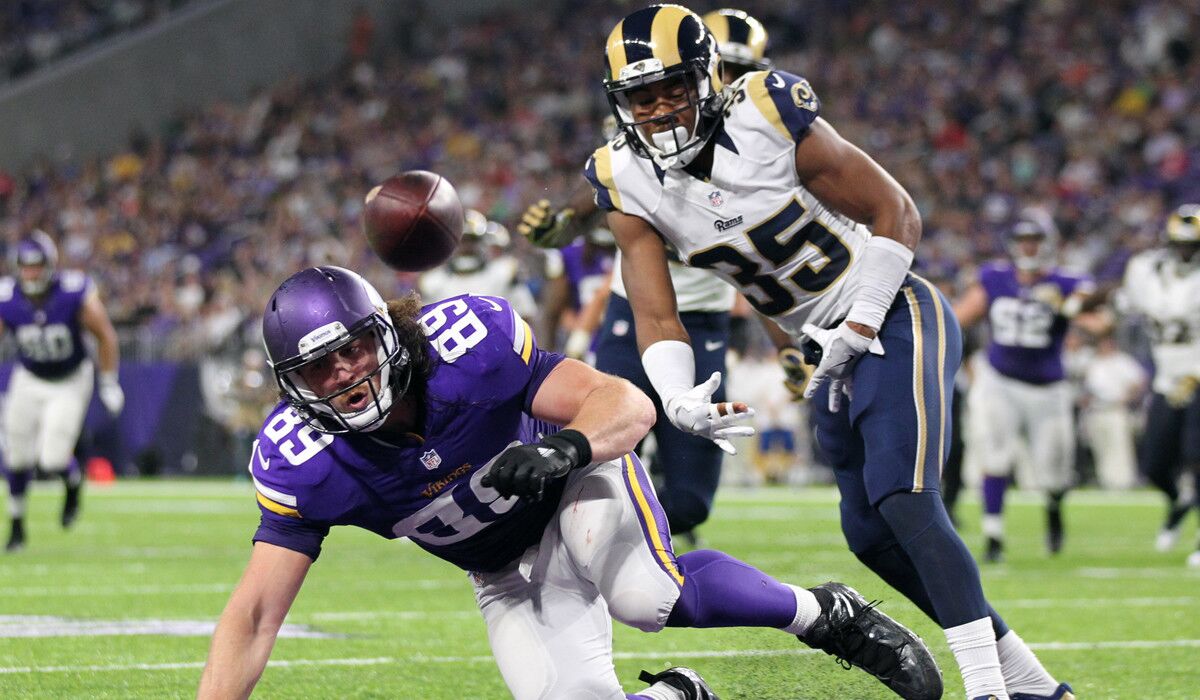 Minnesota Vikings tight end David Morgan, left, tries to make a reception in front of Rams defensive back Michael Jordan during the second half of an NFL preseason game Thursday.