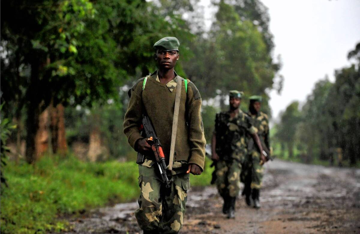 M23 soldiers patrol in Rangira, near Rutshuru, in eastern Congo. United Nations experts say neighboring Rwanda armed and commanded the group, which rebelled against the Congolese army in April.