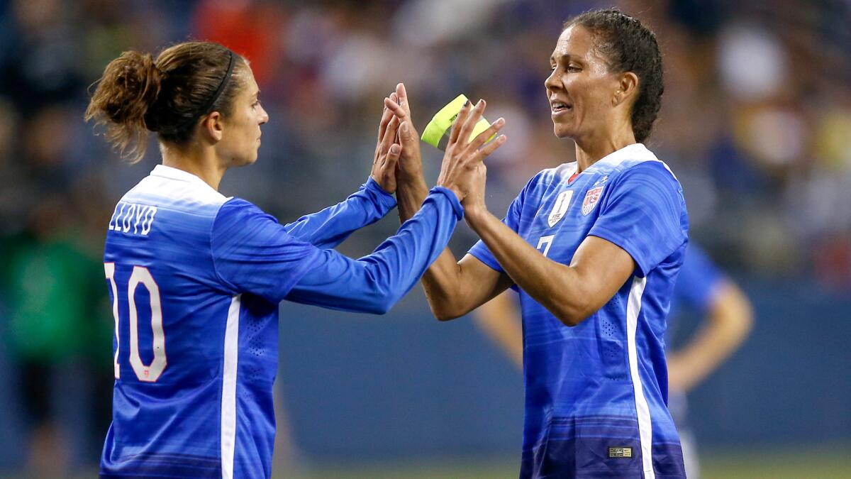 U.S. midfielder Carli Lloyd (10) congratulates fellow midfielder Shannon Boxx as she is removed from her final match with the national team during a 1-1 draw with Brazil on Wednesday in Seattle.