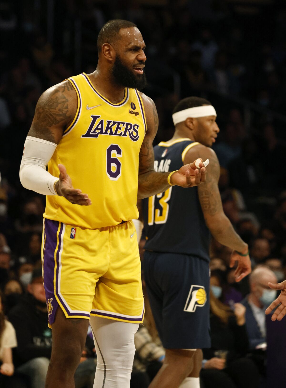 Lakers forward LeBron James questions a technical foul called on forward Carmelo Anthony.