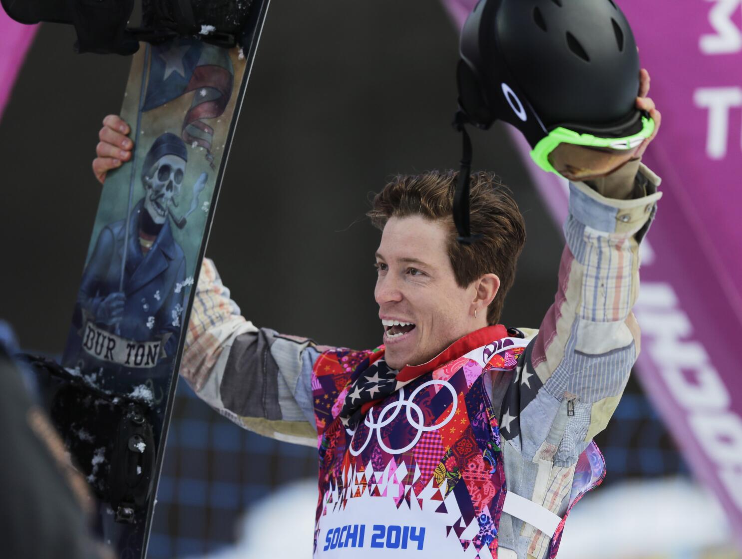 Shaun White, center, celebrates winning a gold medal with his
