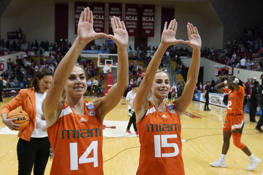 Miami's Haley Cavinder (14) and Hanna Cavinder (15) celebrate after Miami defeated Indiana in a second-round college basketball game in the women's NCAA Tournament Monday, March 20, 2023, in Bloomington, Ind. (AP Photo/Darron Cummings)