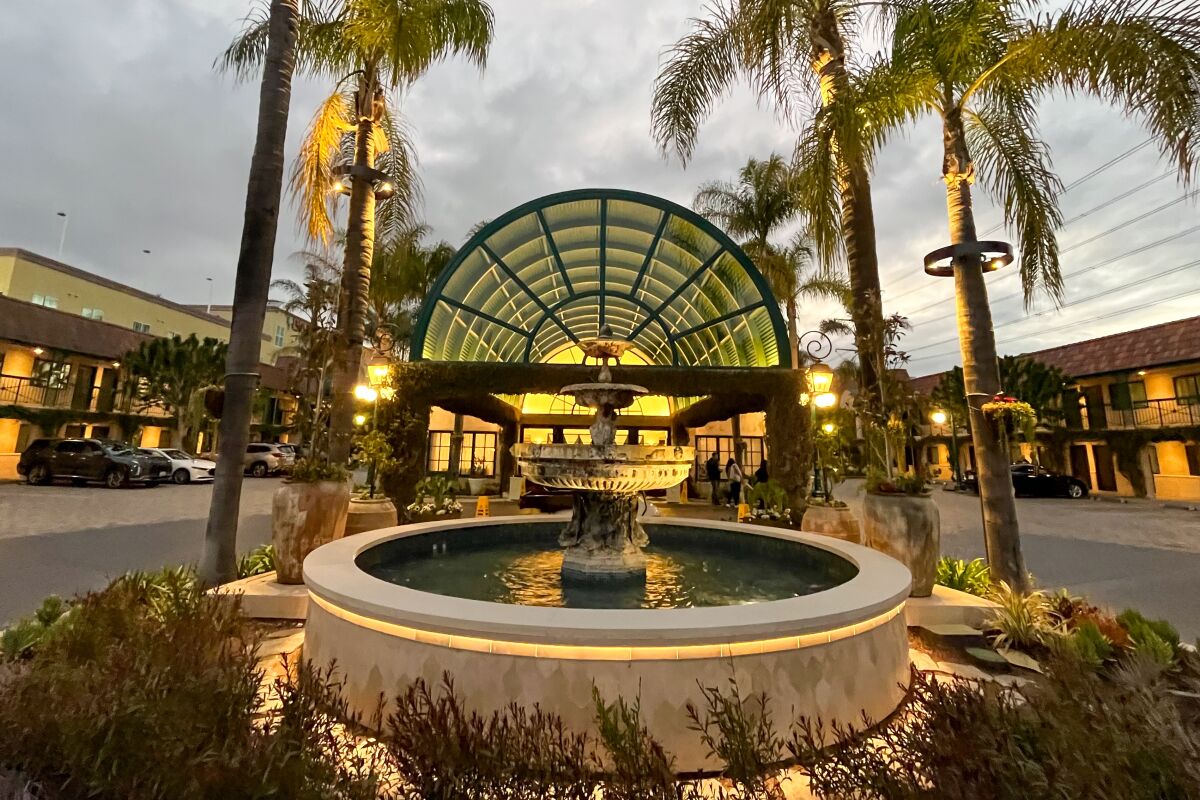 Palm trees flank a fountain outside the Candy Cane Inn