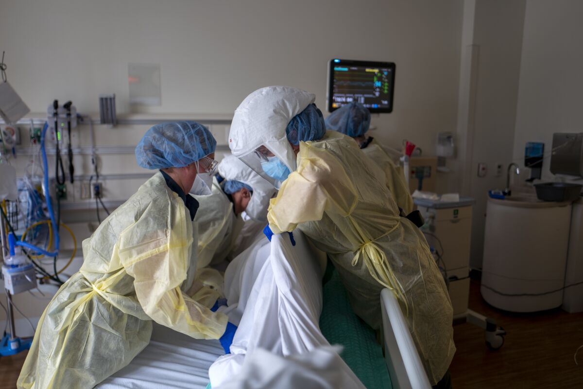 A hospital team repositions a COVID-19 patient inside the ICU at Ventura County Medical Center.