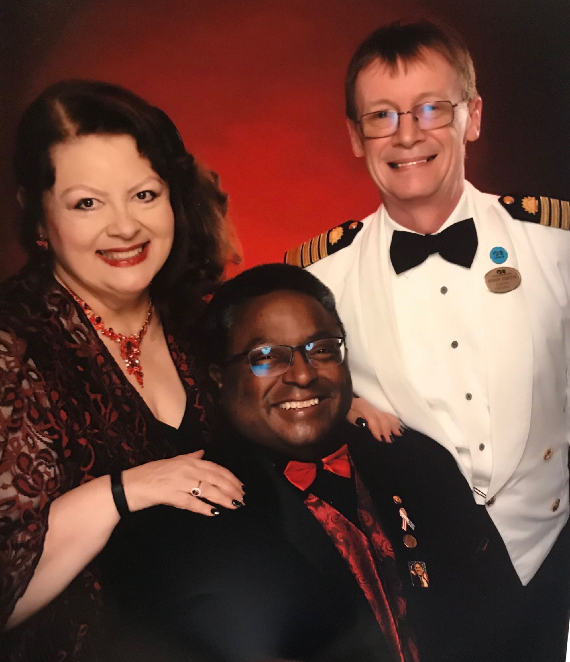 Grand Princess passengers Cheri and Alfred Harris with Capt. John Smith, right.