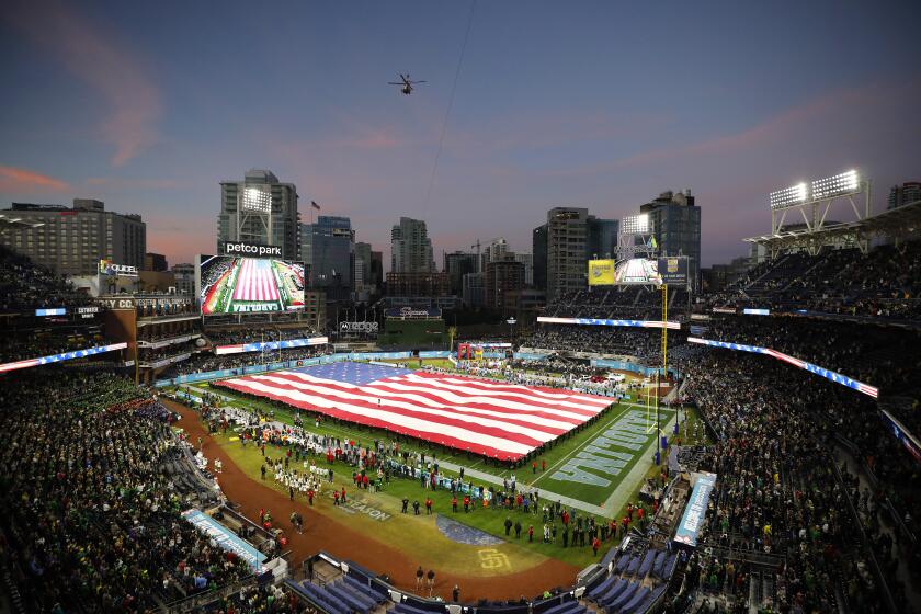 San Diego CA - December 28: Navy personnel unfurl a giant flag for the national anthem before Oregon played North Carolina in the Holiday Bowl at Petco Park on Wednesday, December 28, 2022. (K.C. Alfred / The San Diego Union-Tribune)