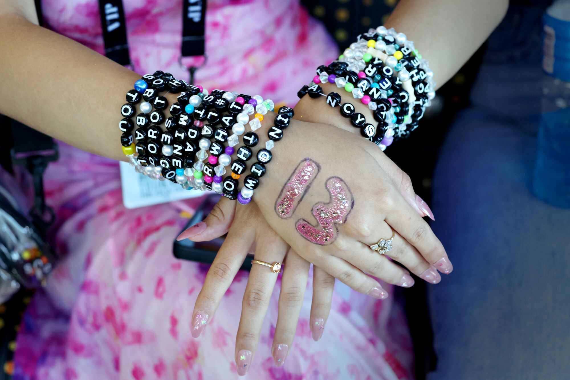 Taylor Swift fan Roselin Alvarez, of Orange County, shows her friendship bracelets.