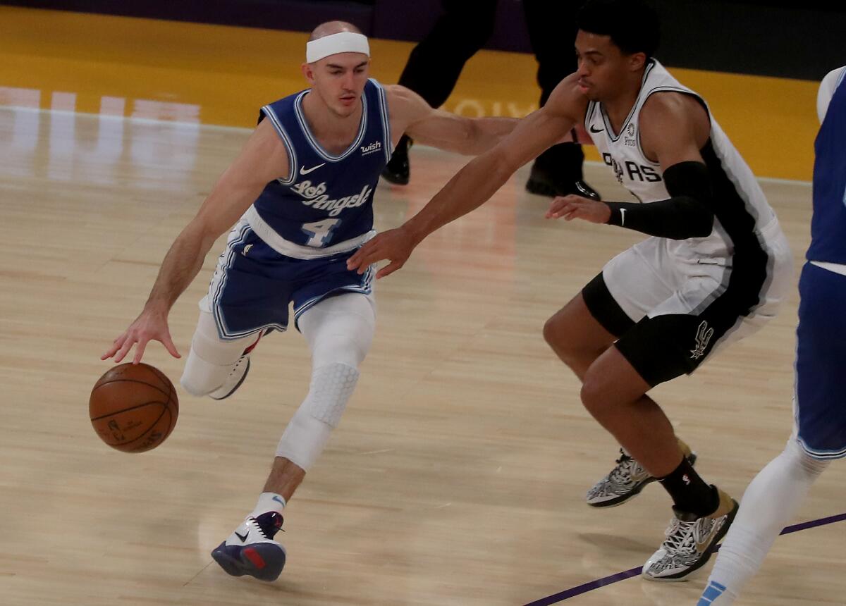 Lakers guard Alex Caruso drives to the basket against San Antonio Spurs forward Keldon Johnson.