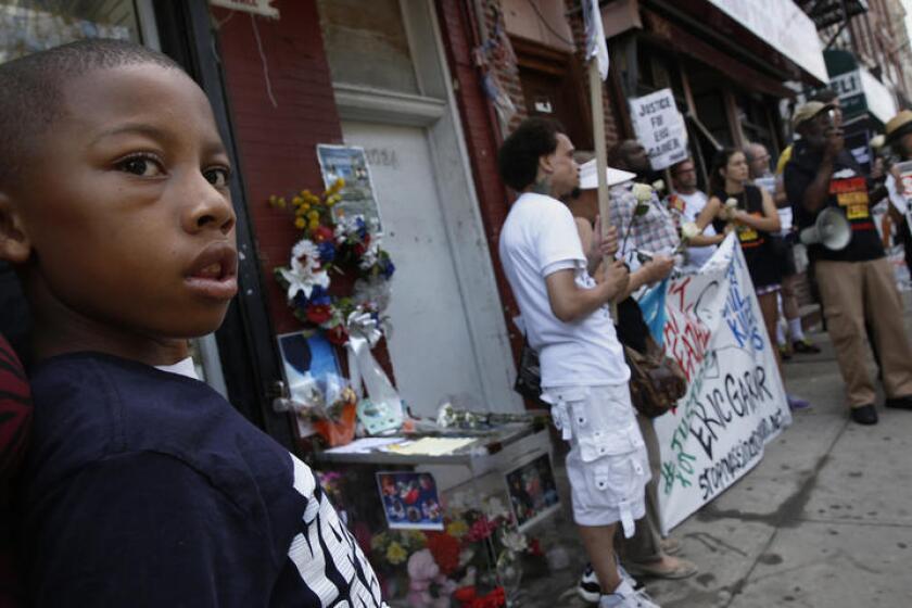 People gather in July 2015 at the Staten Island memorial site for Eric Garner on the one-year anniversary of his death.