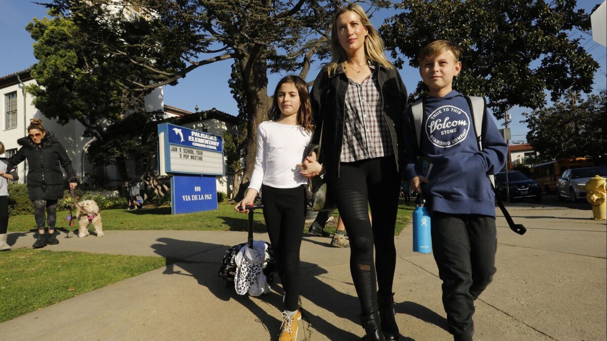 A parent picks up her children from Pacific Palisades Charter Elementary in Pacific Palisades, Calif. on Jan. 9.