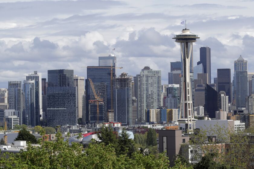 The Space Needle and the Seattle skyline are shown against a cloudy sky, Thursday, April 30, 2020, as seen from Kerry Park. (AP Photo/Ted S. Warren)