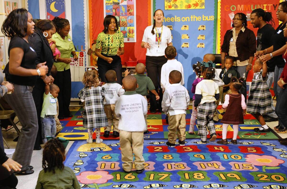 First Lady Michelle Obama exercises with staff, parents and children at the Royal Castle Child Development Center in New Orleans in 2011 as part of her "Let's Move!" campaign.